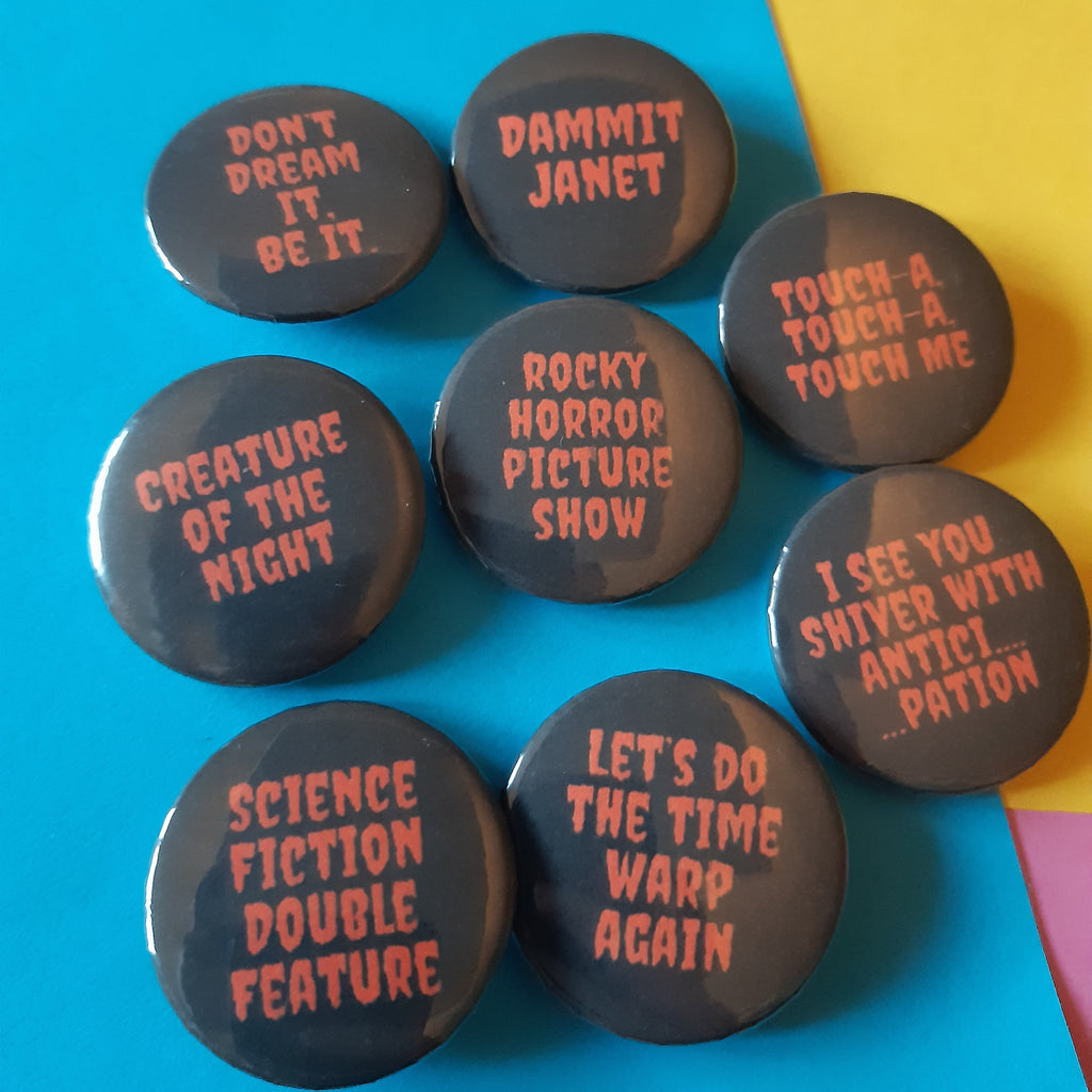 Seven round black pin-back buttons with pink text displaying movie and TV show quotes, arranged on a bright blue and yellow background.