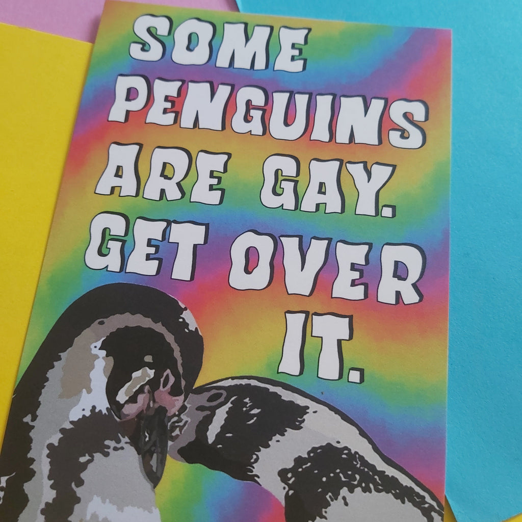 A rectangular print with a rainbow tie-dye background and a stylised penguin illustration at the bottom left, featuring the text 'SOME PENGUINS ARE GAY. GET OVER IT.