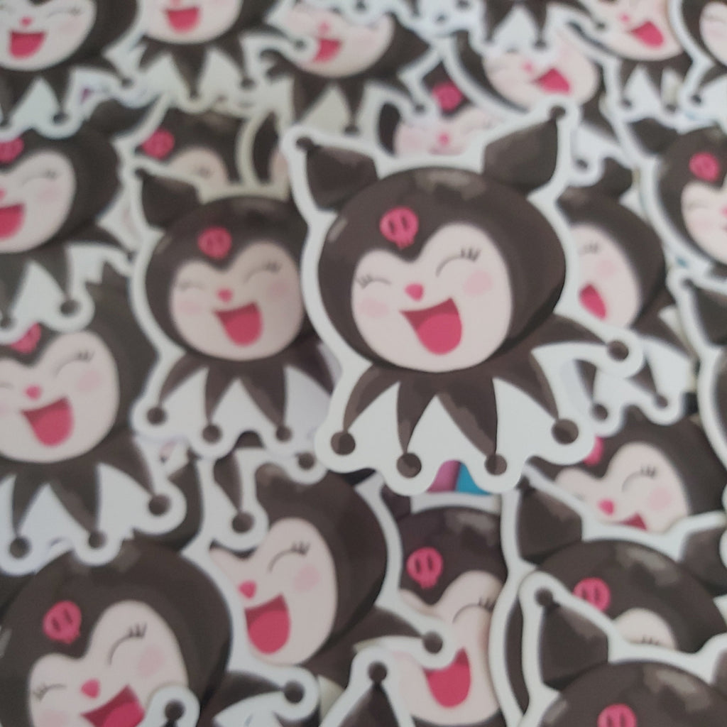 A dense pile of cartoon character stickers featuring a black-haired character with a pink bow and a wide open smile, shown close up.