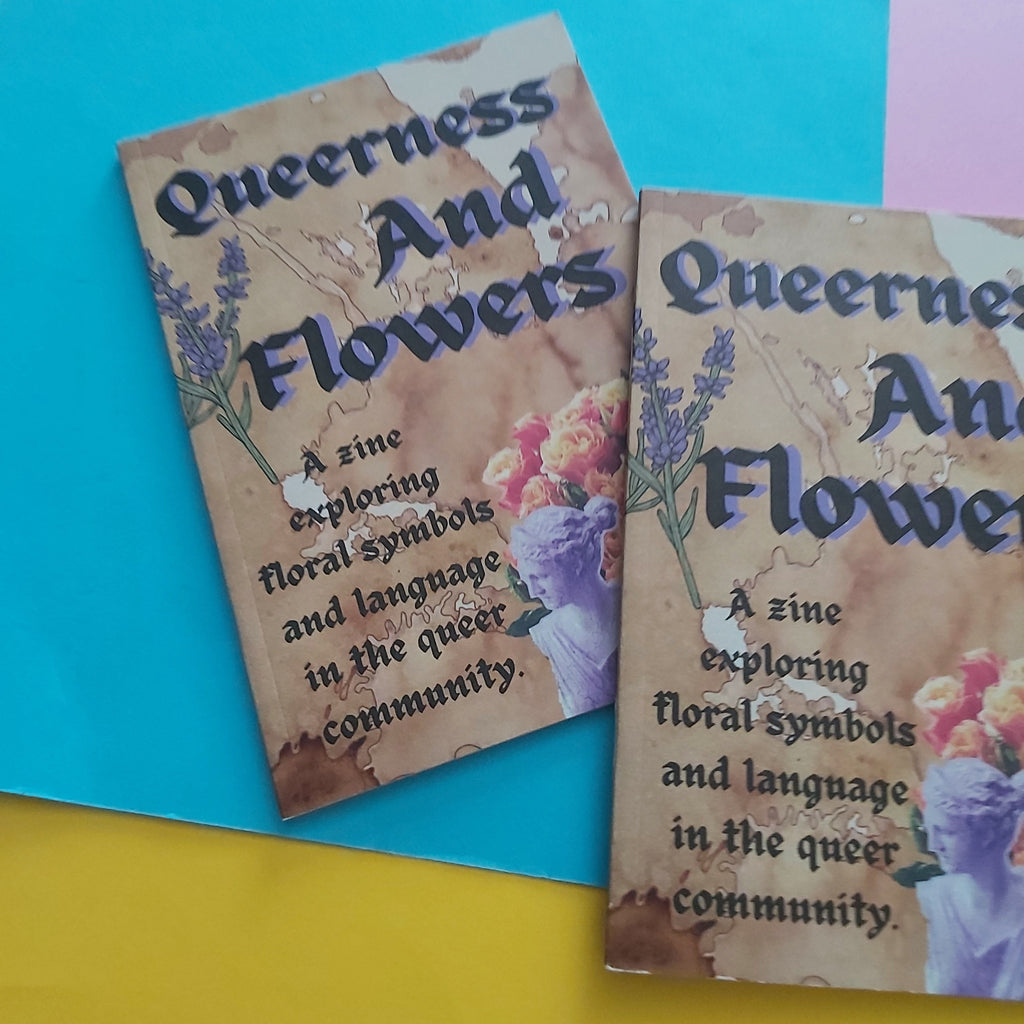 Two printed zine covers titled "Queerness And Flowers" are shown on a bright multicoloured background with blue, yellow, and pink sections. The covers have a parchment-like tan background with floral illustrations and dark text.
