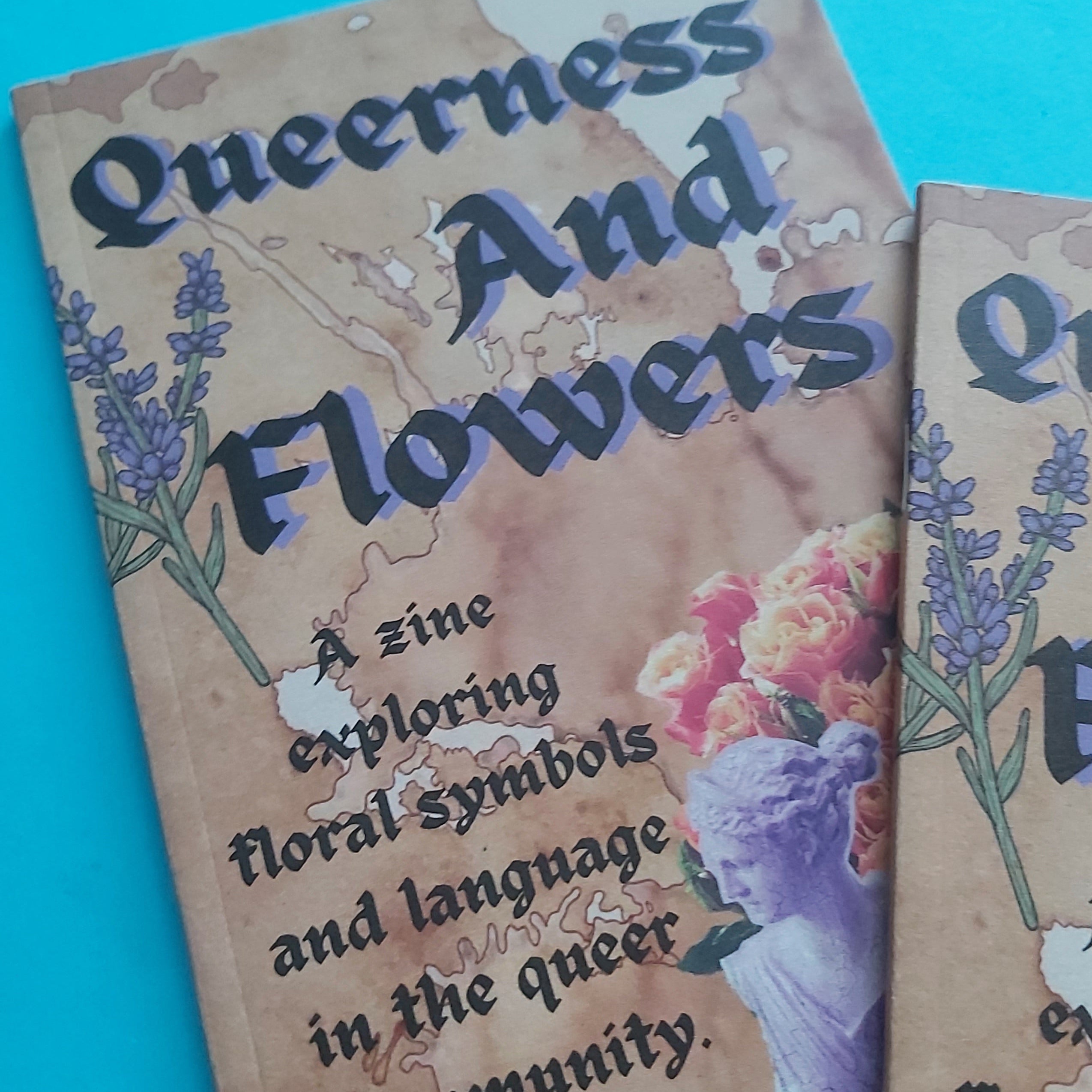 A close-up of a zine cover titled "Queerness And Flowers" on a bright turquoise background, with additional copies partially visible at the right edge.