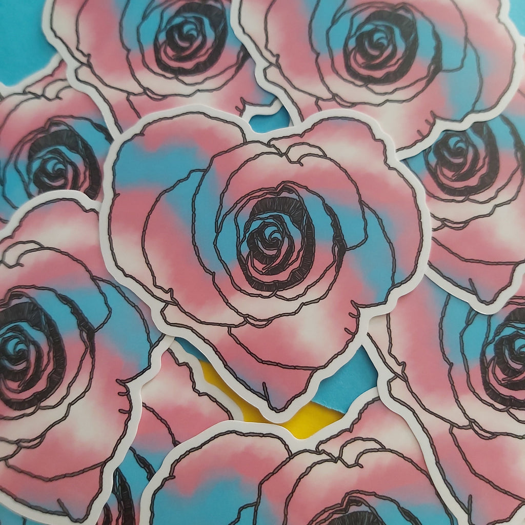 A close-up of multiple die-cut stickers featuring stylized pink and blue roses with black outlines and white borders, arranged on a bright blue background.