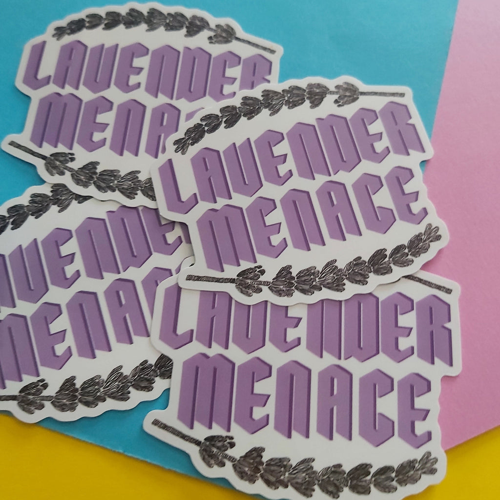 Several die-cut stickers featuring the phrase 'LAVENDER MENACE' in purple retro lettering with a black lavender sprig illustration, arranged on a bright multicolour background of blue, pink, and yellow.