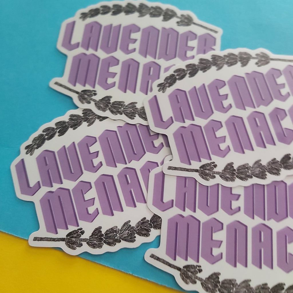 Four die-cut stickers featuring the phrase 'LAVENDER MENACE' in stylised purple lettering with a lavender sprig border, arranged on a split blue and yellow background.