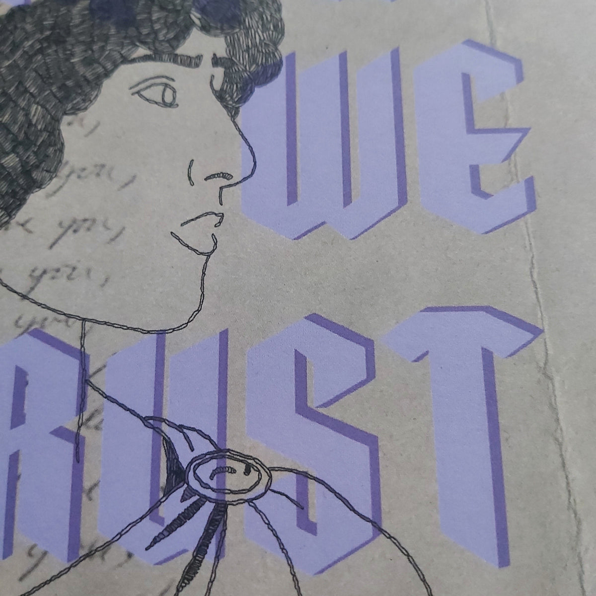 A close-up of a print featuring a black line-art portrait of a woman's face in profile, overlaid with large lavender-purple block letters and faint handwritten text on a beige background.