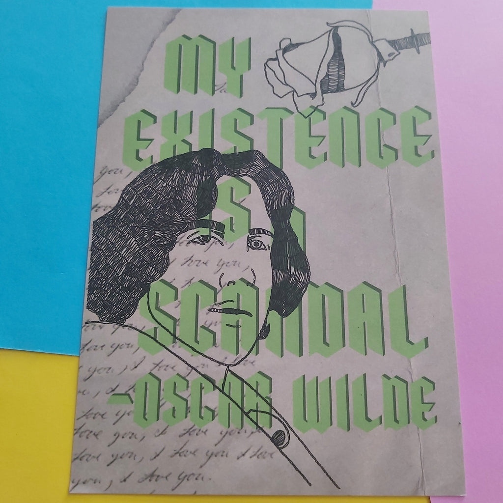 An art print featuring a black ink illustration of Oscar Wilde with the title 'MY EXISTENCE IS A SCANDAL -OSCAR WILDE' in large green letters, displayed on a colourful background of yellow, pink, and blue paper.