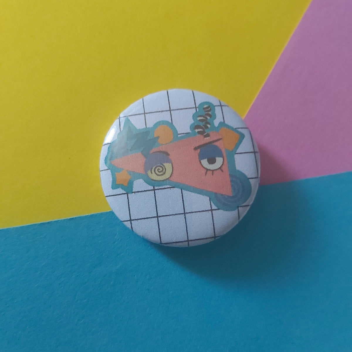 A round pinback button badge featuring a cartoon character on a white grid background.