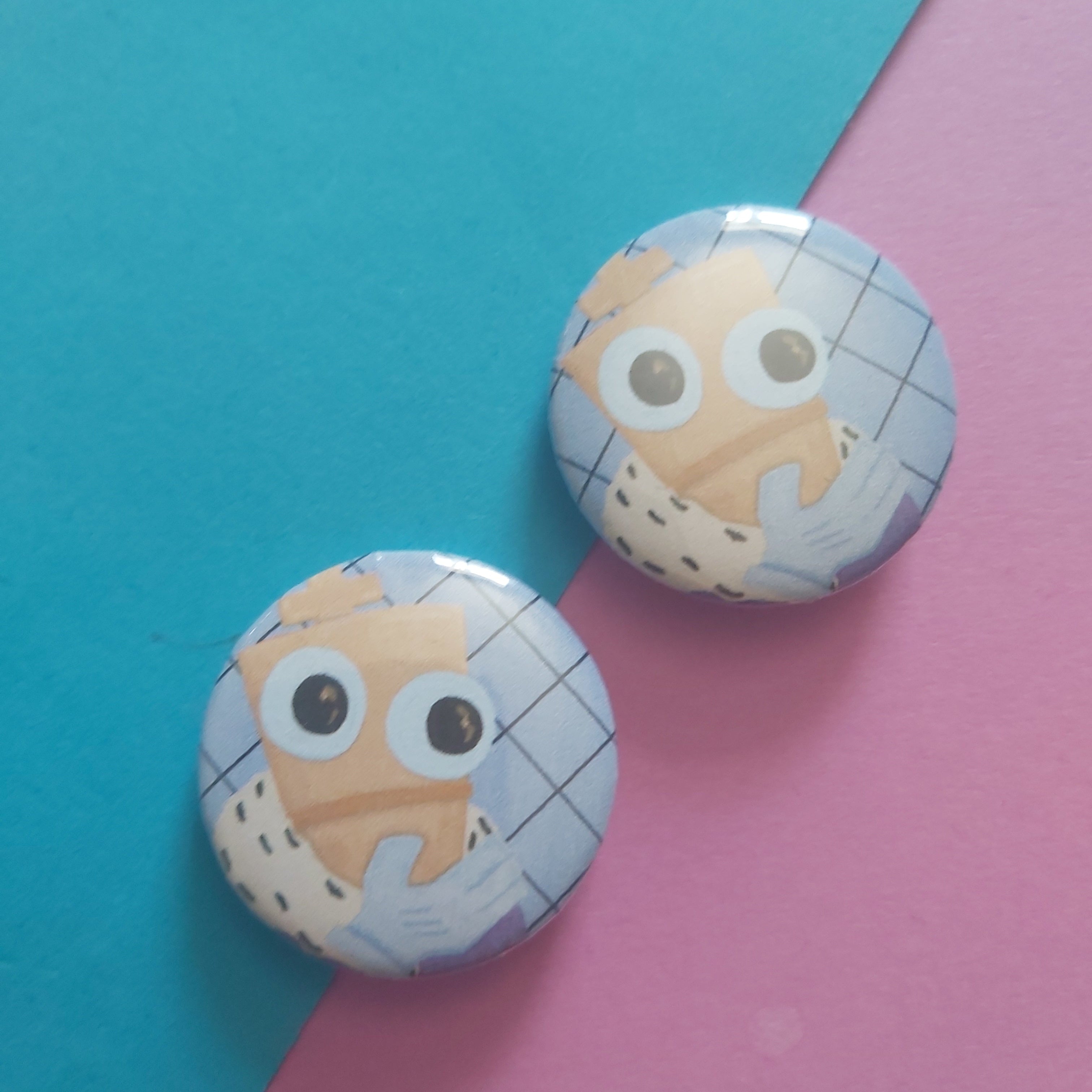 Two round badges with cartoon chess piece designs on a diagonal split blue and pink background.