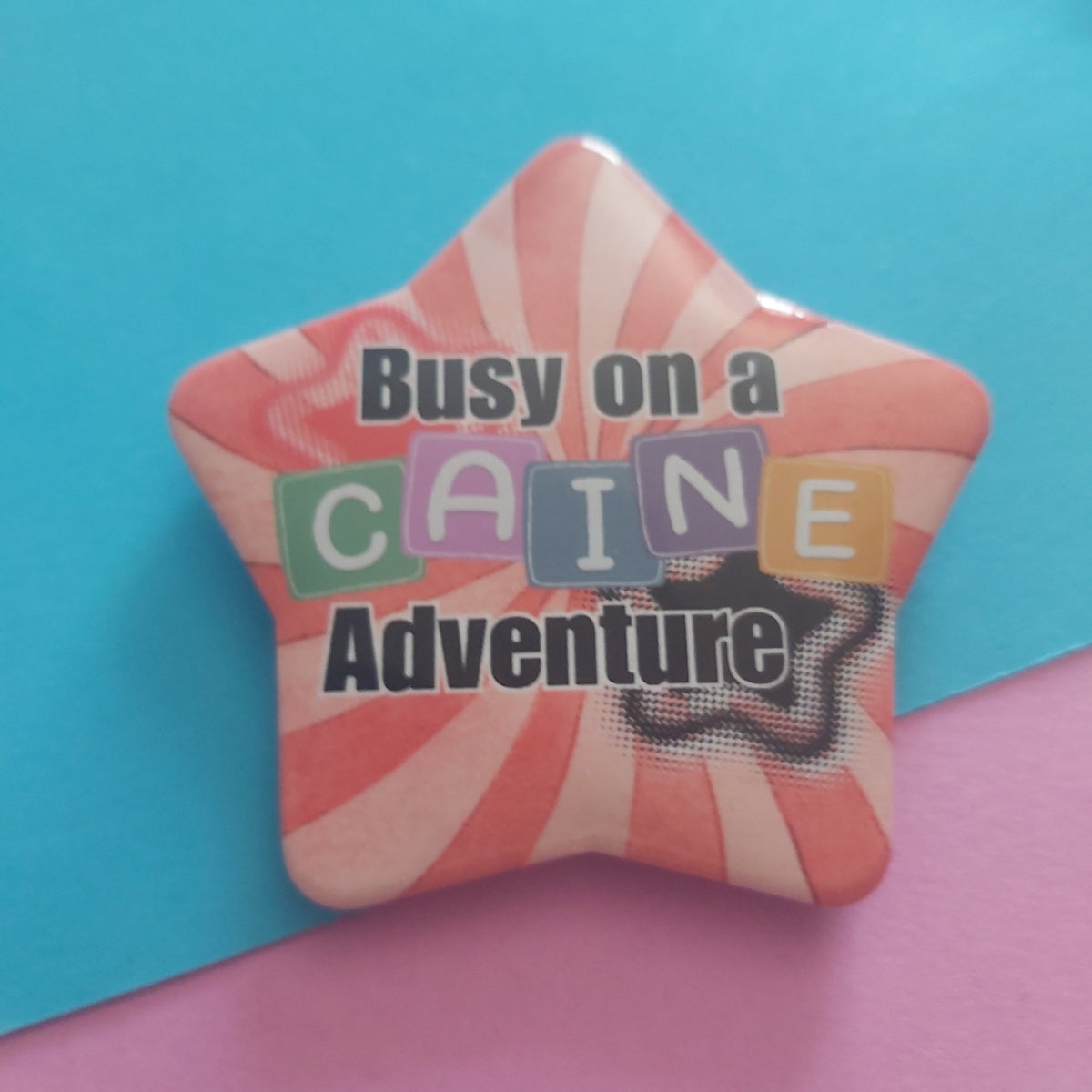 Busy on a Caine Adventure Star-Shaped 58mm Badge – TADC Digital Circus Clown Pin Accessory