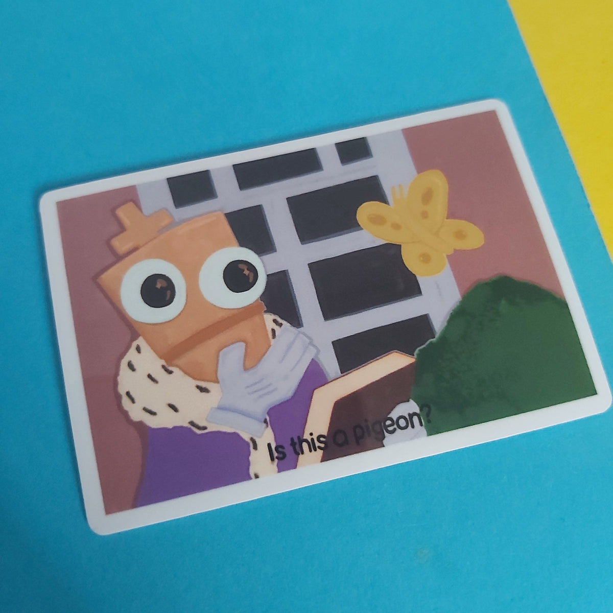 A rectangular printed sticker featuring a cartoon illustration of a chess piece figure and a yellow butterfly, photographed on a bright blue background with a yellow corner visible.