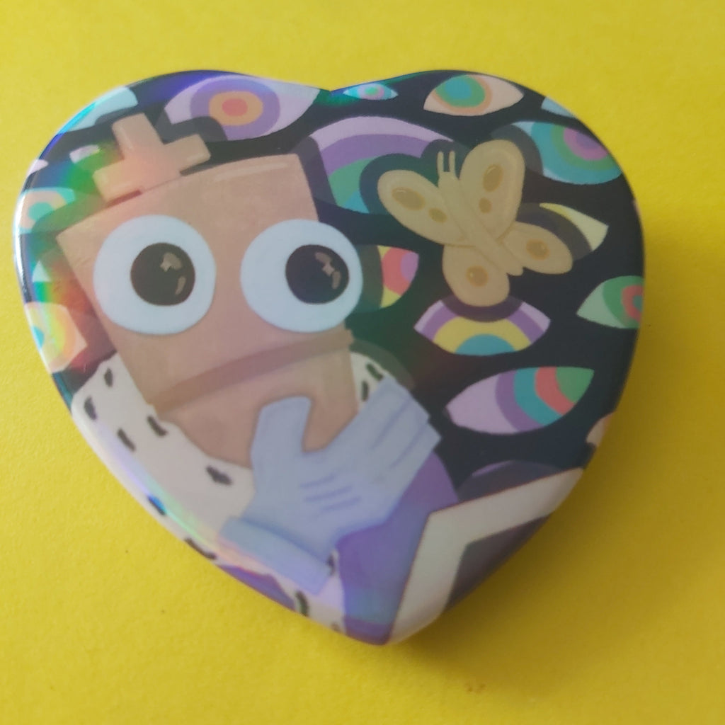 A heart-shaped pinback button featuring a cartoon illustration of a character with large eyes and a butterfly, set against a bright yellow background.