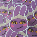 A close-up of multiple purple cartoon bunny Jax stickers with yellow eyes, pink cheeks, and a white maid hat, overlapping each other.