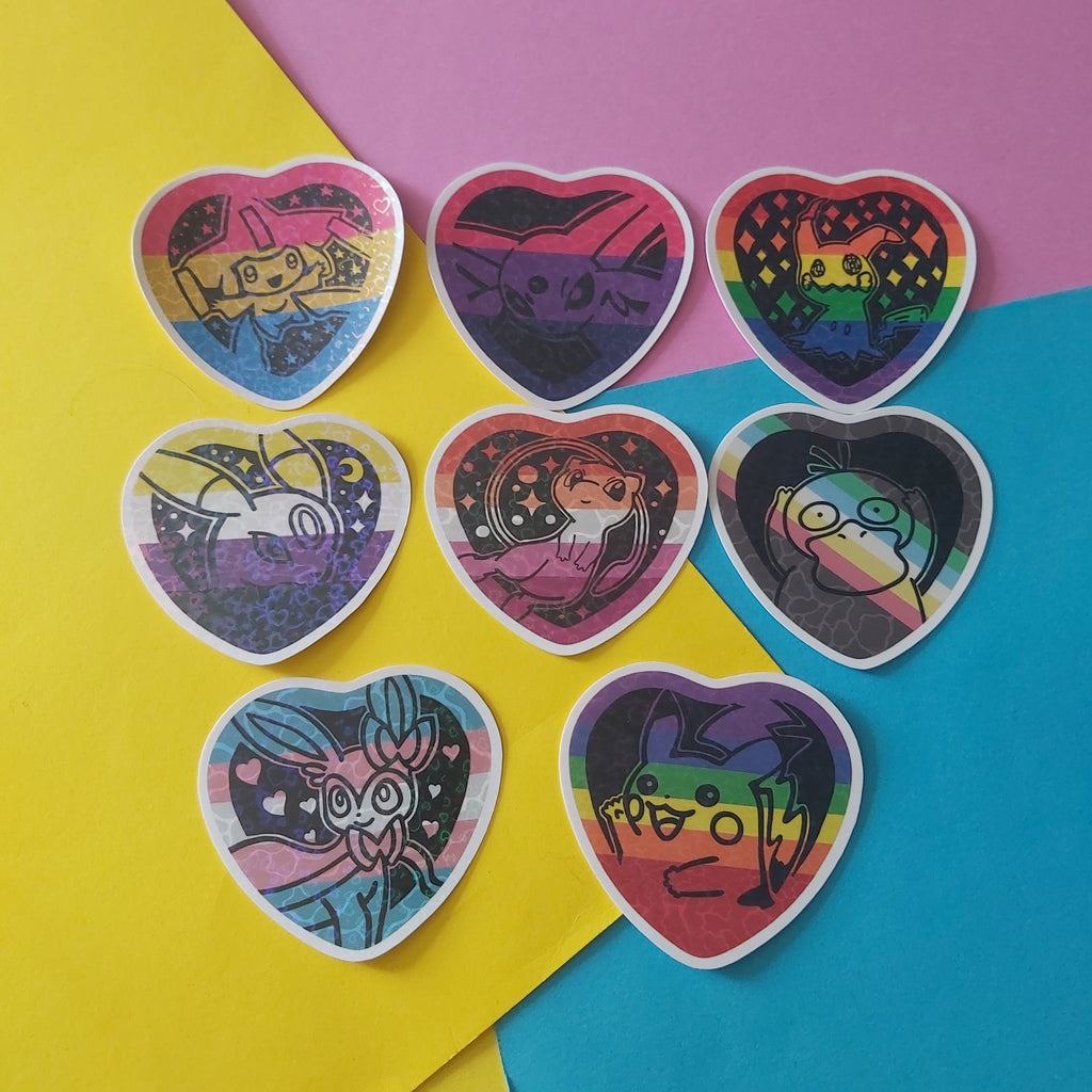Seven heart-shaped stickers with colorful pokemon illustrations arranged on a diagonally split yellow and pink background.