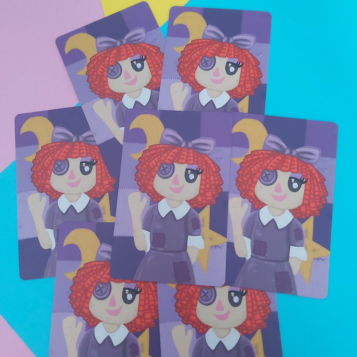 Six illustrated cards featuring a cartoon girl with red curly hair, a purple bow, and a purple dress, arranged in a fan shape on a colorful pastel background.