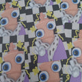 A close-up of a repeating printed pattern featuring a cartoon character with large blue eyes, a peach chess piece body, a purple outfit, and a black-and-white checkerboard background with small yellow motifs.