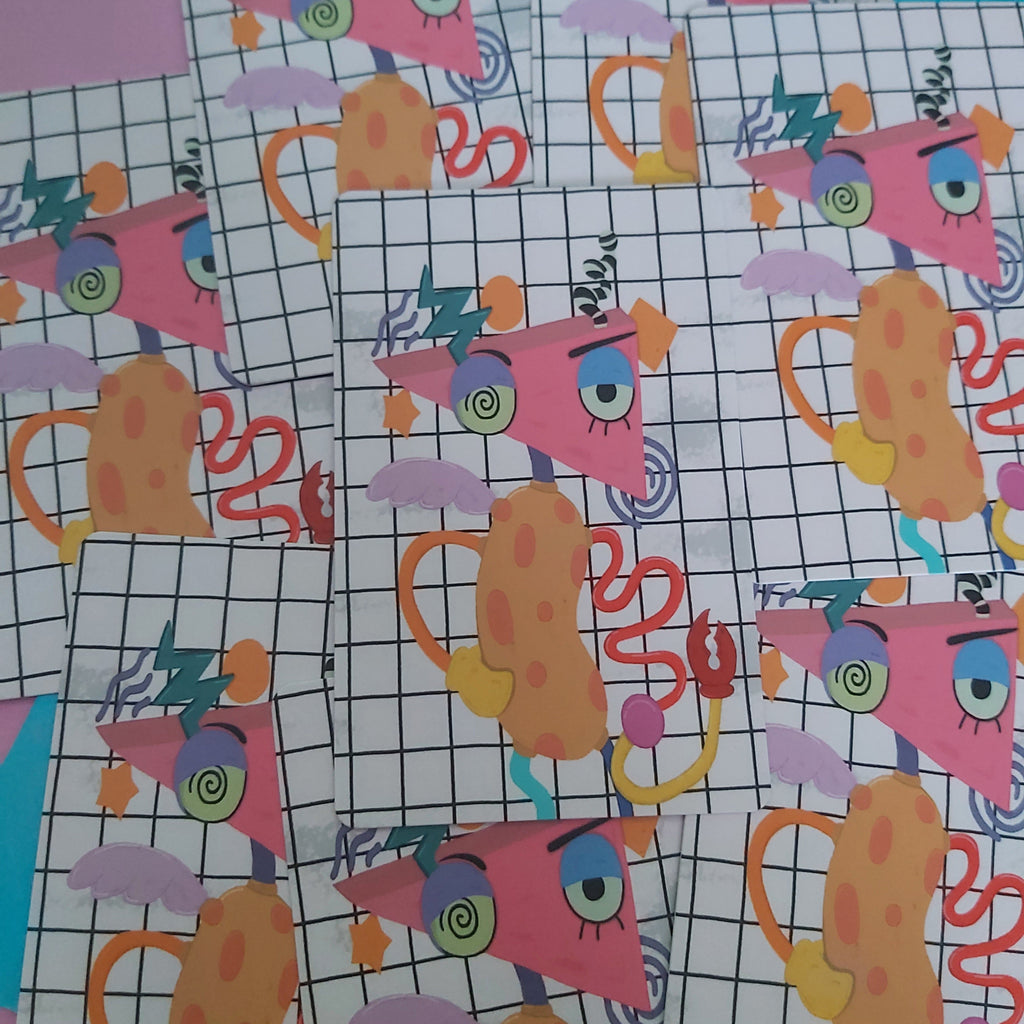 A pile of cards featuring a whimsical cartoon design of a pink triangle character with a single eye, set against a white grid background.