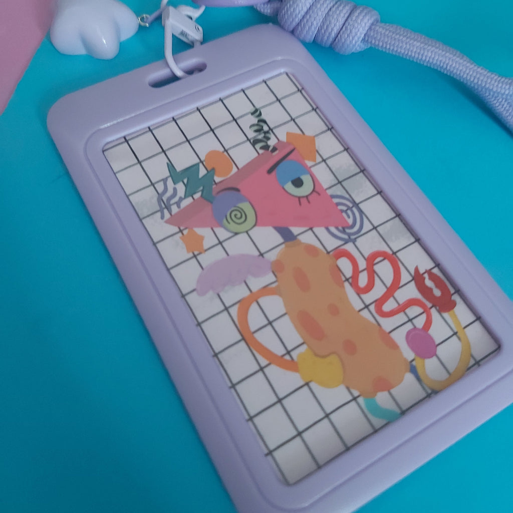 A lavender purple card holder with a colourful cartoon character printed on the front, featuring a matching braided lanyard and lilac plastic heart-shaped charm, set against a bright blue background.