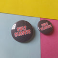 Two round pin-back buttons with a glossy black background and red text reading 'CULT CLASSIC'