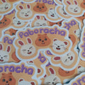 A pile of cute cartoon stickers featuring the word 'Paboracha' in purple lettering, with white bunny and ferret faces, brown quokka illustrations, and pink accents on a peach background.