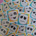 A pile of small stickers featuring cartoon mask faces in different expressions, including sad, happy, and confused looks, with turquoise, yellow, and pink border accents.