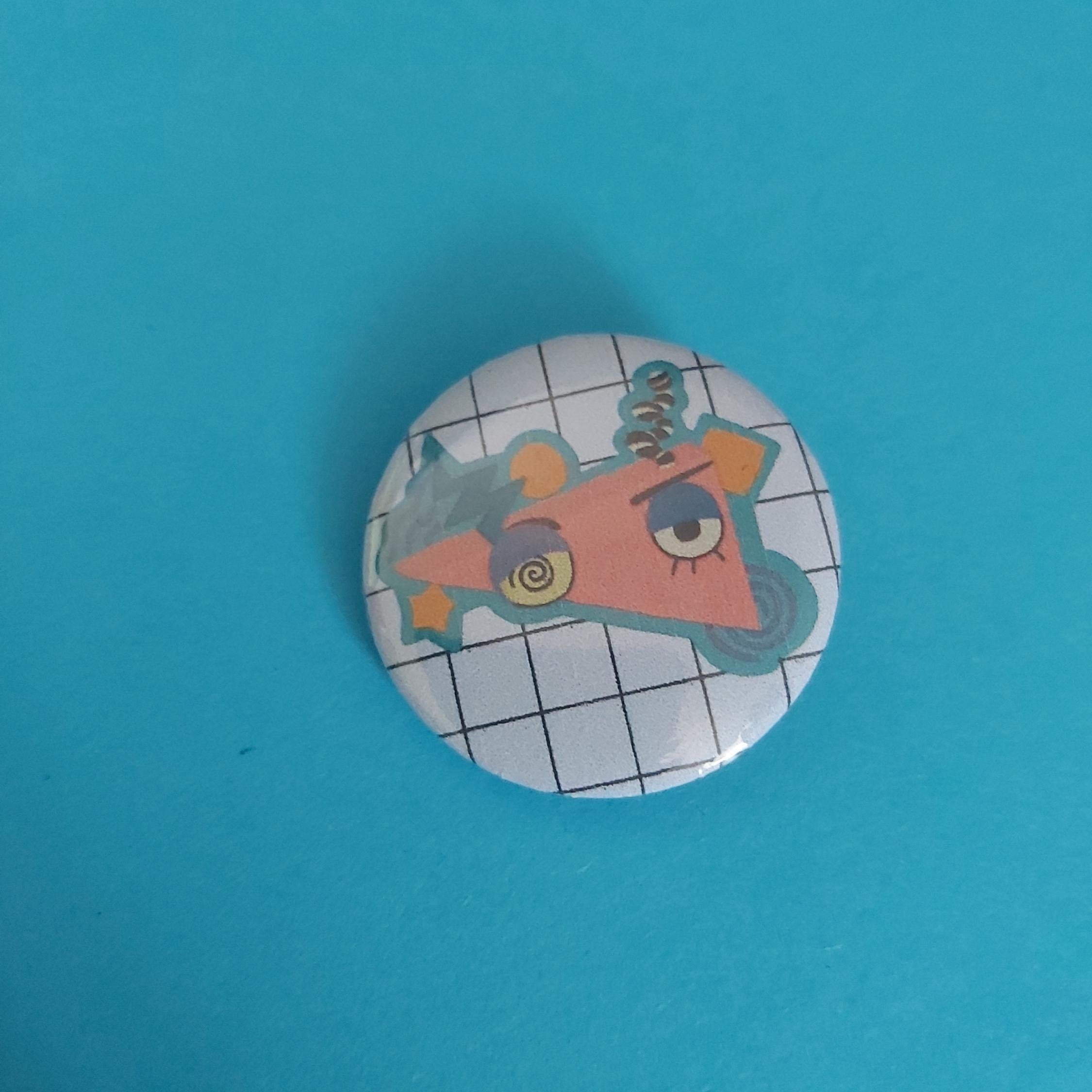 A round pinback button badge featuring a cartoon character on a white grid background.